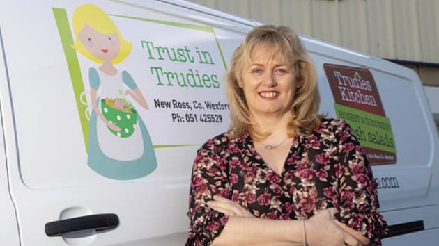 Trudie standing infront of her company van for 'Trudie's Kitchen'