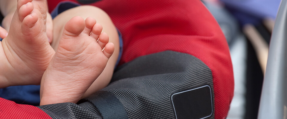 Close up of babys feet in car seat